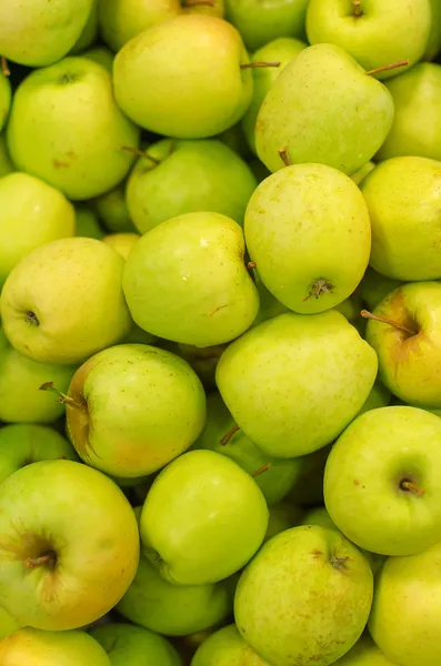 Un montón de manzanas verdes brillantes en el supermercado —  Fotos de Stock