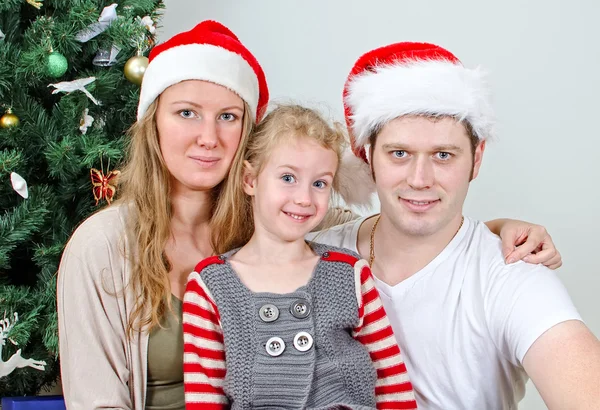 Happy family portrait in front of christmas tree. — Stock Photo, Image