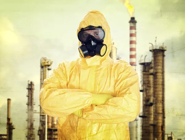 Man in chemical protective suit over factory — Stock Photo, Image