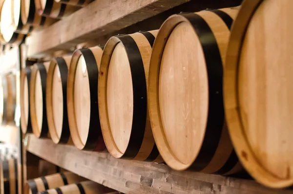 Wine barrels stacked in the cellar. — Stock Photo, Image