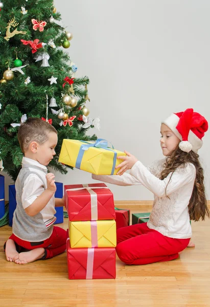 Brother and sister packing christmas gifts Stock Image