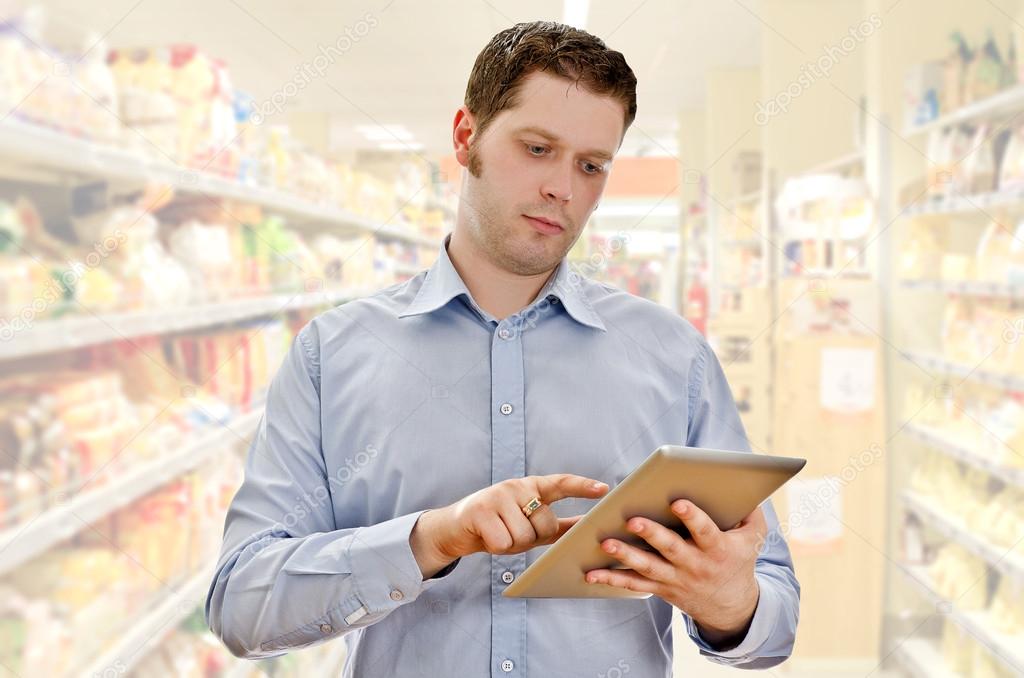 Supervisor with tablet pc in the grocery store