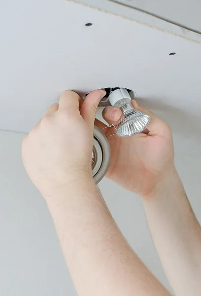 Male hands installing light bulb — Stock Photo, Image