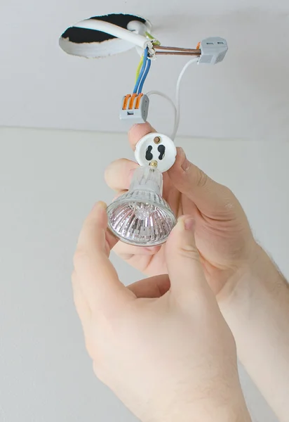 Male hands installing socket for light bulb — Stock Photo, Image