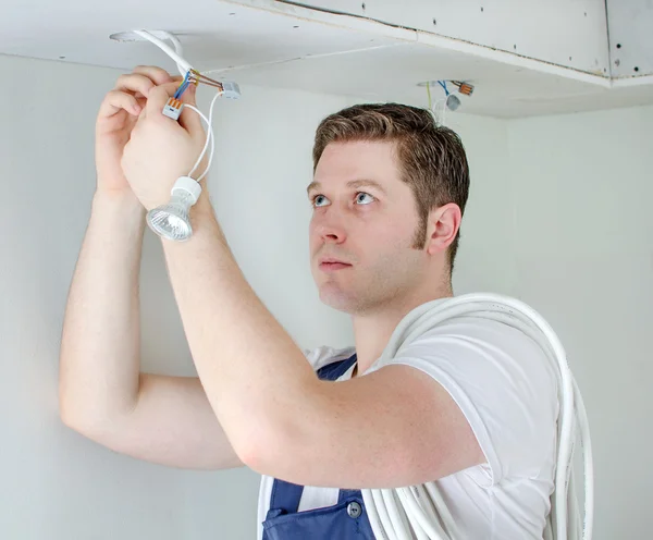 Certified electrician installing socket for light bulb — Stock Photo, Image