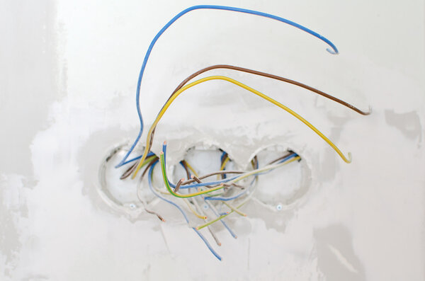 Undone AC power socket in wall. Repairs in the apartment.