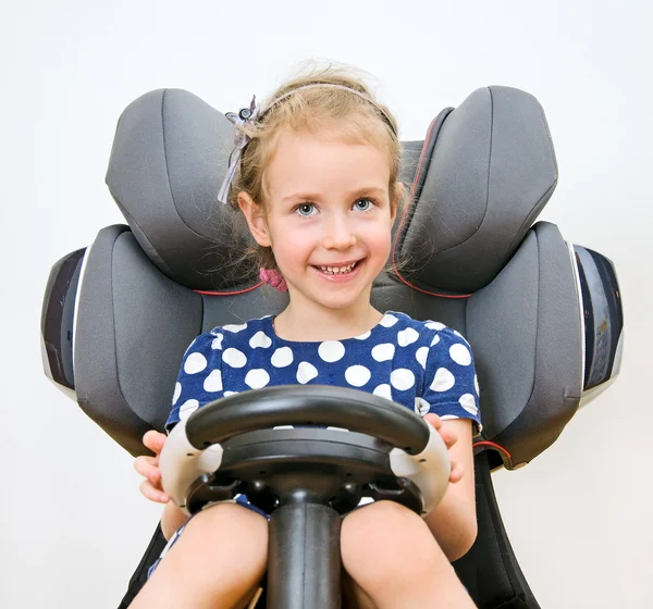 Niña sonriente sosteniendo el volante . — Foto de Stock