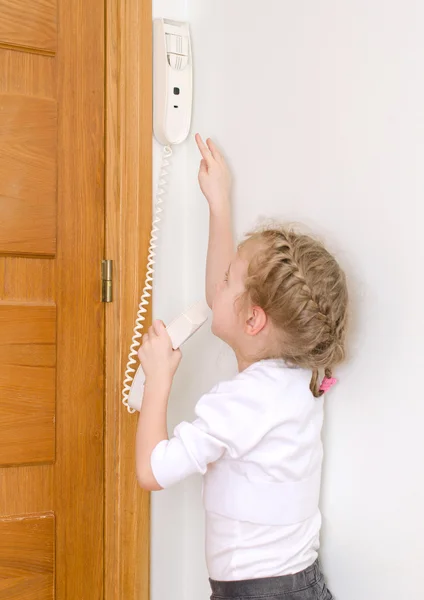 Little girl talking on the intercom at home. — Stock Photo, Image