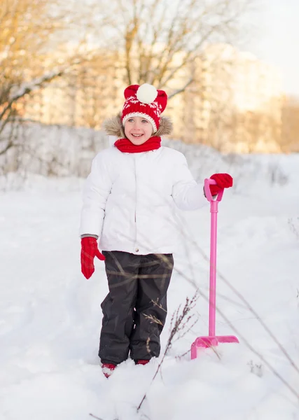 Pretty little girl standing with shovel. — Stock Photo, Image