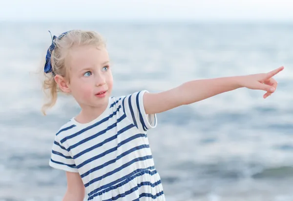 Little girl points direction by her finger. — Stock Photo, Image