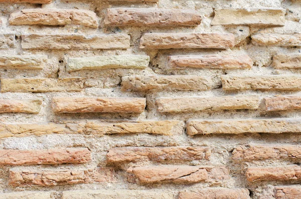 Zeer oude bakstenen muur gebouwd. — Stockfoto