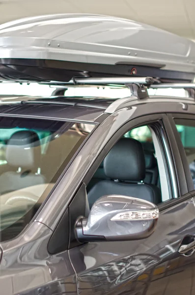 Car with roof cargo at dealership salon. — Stock Photo, Image