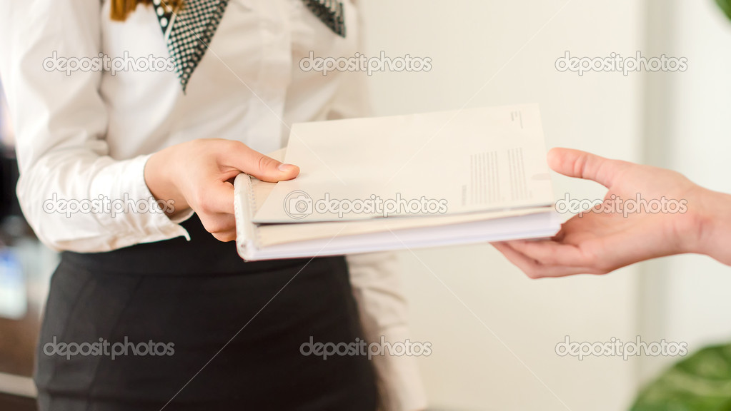 Female hands holding documents. Agreement concept.