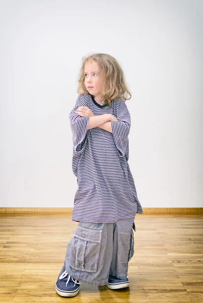 Little girl posing in oversized shorts and shirt. — Stock Photo, Image