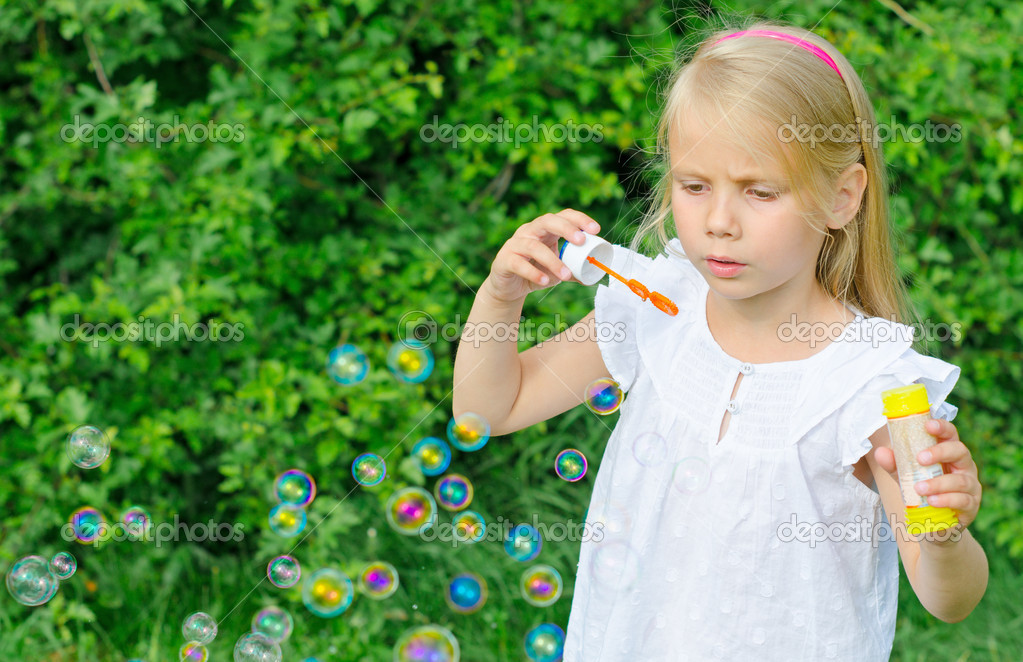 Happy Woman Blowing Soap Bubbles Stock Image