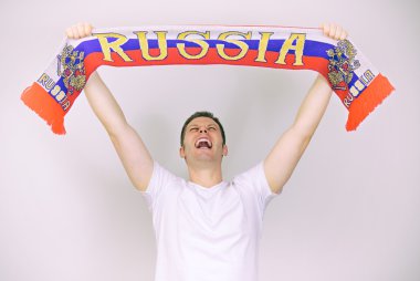 Man supports Russian team with Russian scarf. clipart