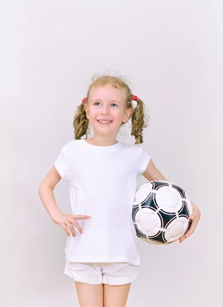 Little girl with ball smiling. Space for text. — Stock Photo, Image