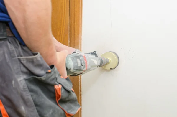 Man with Hammer drill doing hole for socket. — Stock Photo, Image