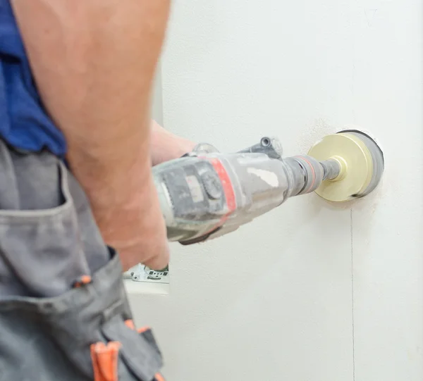 Man with Hammer drill doing hole for socket. — Stock Photo, Image