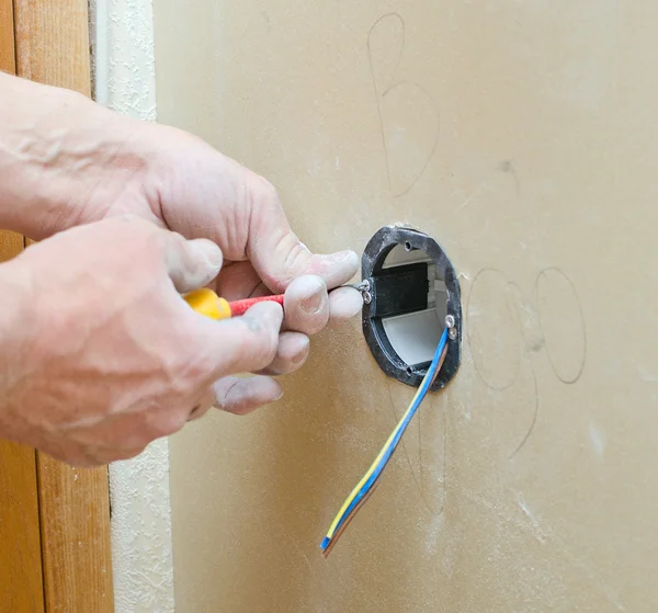 Certified electrician installing socket for light switch. — Stock Photo, Image