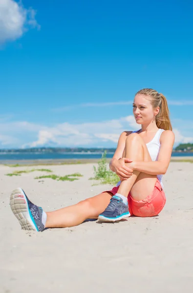 Young woman stretches before doing sports. — Stock Photo, Image