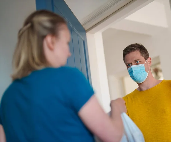 stock image Masked man delivers food during pandemic.