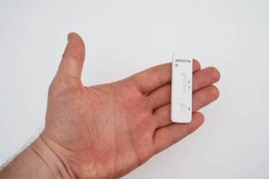 Elinde COVID-19 antijen testi tutan adam..