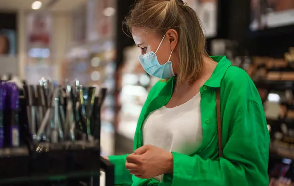 Woman trying cosmetics products in the cosmetics store.