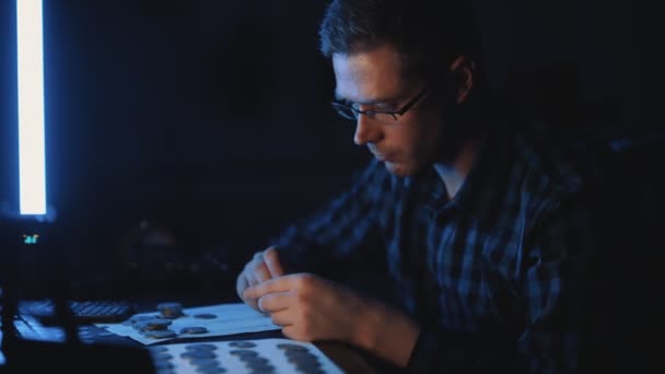 Male Numismatist Examines Collection Coins — Stock Video