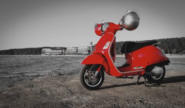 Deniz kıyısında kırmızı renkli scooter..