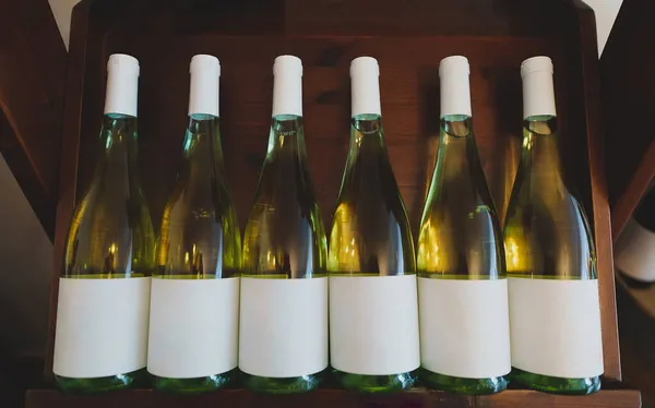White Wine Bottles Stacked Wooden Rack — Stock Photo, Image
