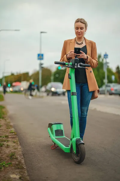 Wanita Yang Menggunakan Aplikasi Pada Smartphone Untuk Membuka Scooter Listrik — Stok Foto