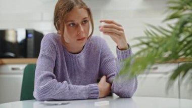 Okullu kız evde COVID-19 antijen testi yapıyor..