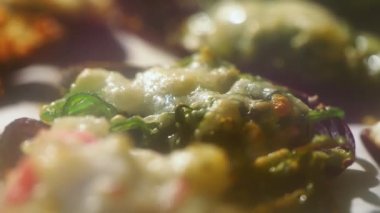 Baking of stuffed fresh mussels in shell.