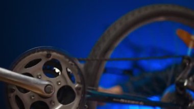 Technician examines wheel of the bicycle. Bicycle repair workshop.