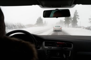 Blowing snow on the road. Difficult weather conditions on the road.