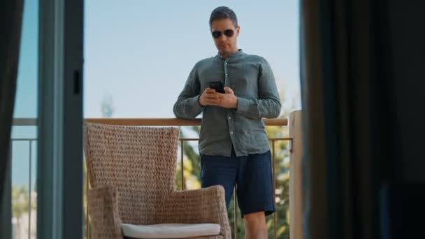Άνθρωπος Στο Μπαλκόνι Χρησιμοποιώντας Smartphone — Αρχείο Βίντεο
