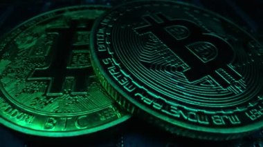Macro view of golden bitcoin with changing color.