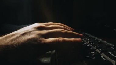 Man is typing on a keyboard.