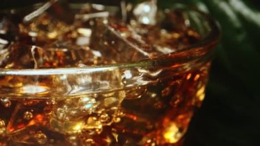 Macro shoot of cola with ice cubes.