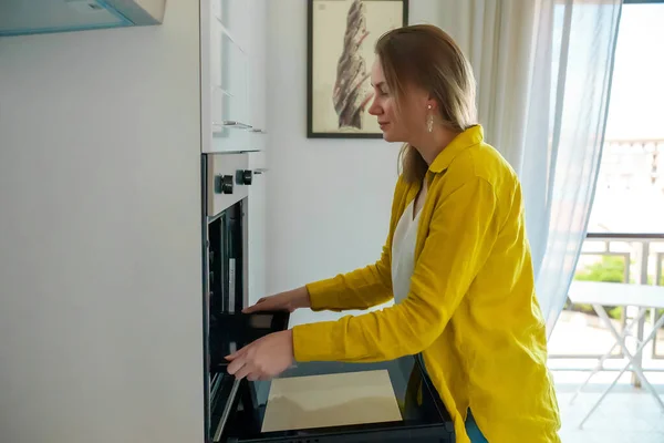 Woman Opens Oven Cook Food — Stockfoto