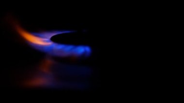 Gas cooker with burning flames of blue propane gas.