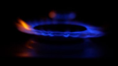 Gas cooker with burning flames of blue propane gas.