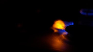 Gas cooker with burning flames of blue propane gas.