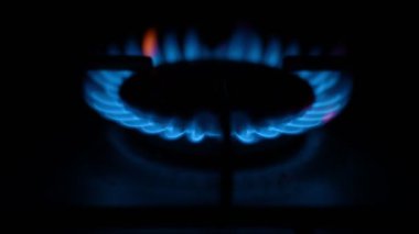 Gas cooker with burning flames of blue propane gas.