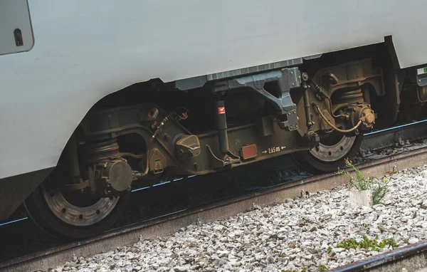 Wheels of a passenger train wagon close-up.
