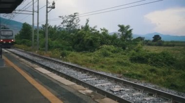 High-speed train passing by the train station.