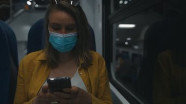 Woman in medical mask travels on a train.