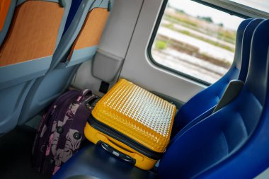 Two suitcases lie in the train.