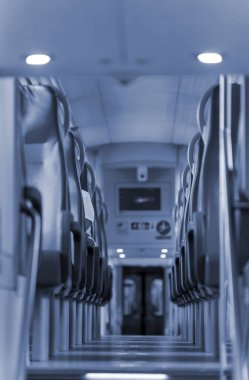 Aisle with seats in double decker train.